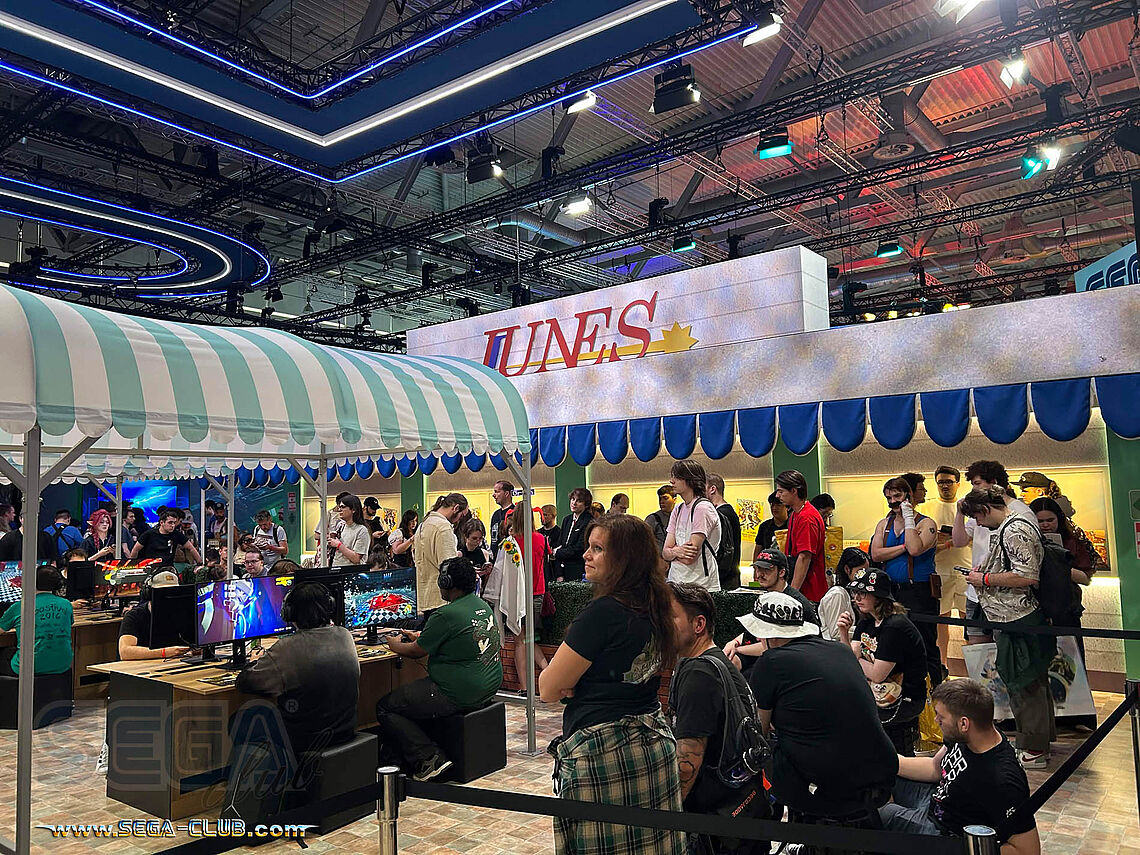 Junes: Der Persona 4 Platz nachgebaut mit vielen Spielern wartend, um die Markise und Spiele-Demos betreten zu dürfen